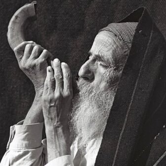 Man blowing a shofar.