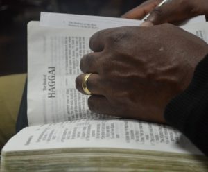 Hand turning Bible pages